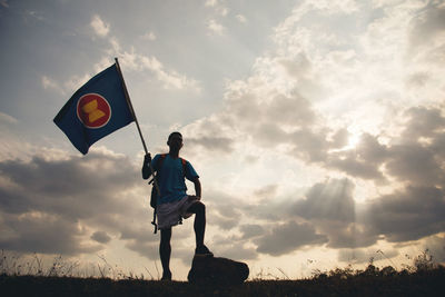 Man standing on field against sky