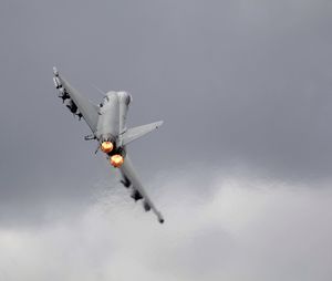 Low angle view of airplane flying against sky