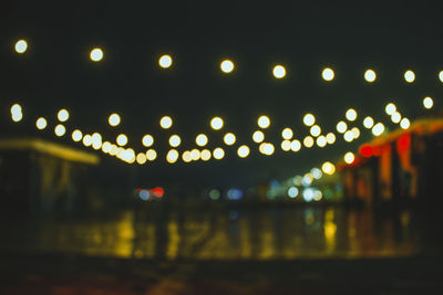 Defocused image of illuminated street lights at night