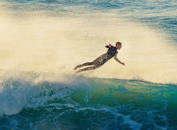 People surfing in sea