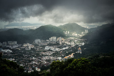 High angle view of townscape by mountains against sky