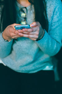 Close-up of woman using mobile phone