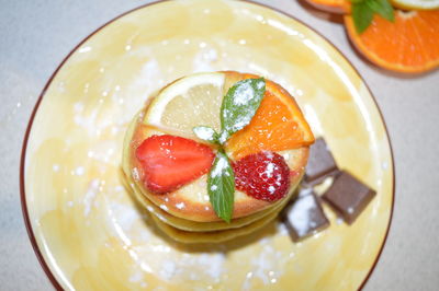 High angle view of fruits in plate on table