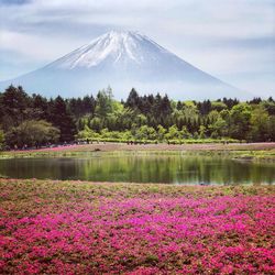 Scenic view of lake by mountain against sky