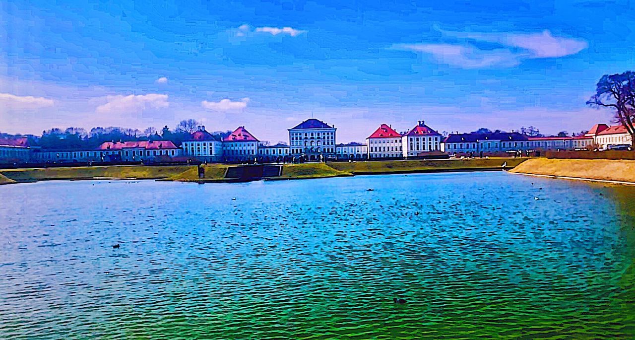 architecture, sky, built structure, cloud - sky, multi colored, building exterior, blue, water, outdoors, no people, sea, day, city, nature