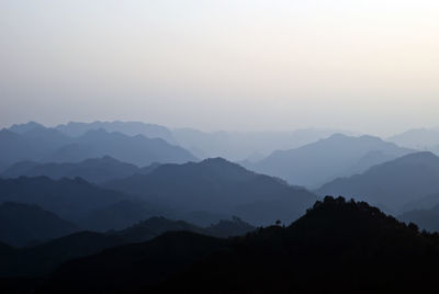 Scenic view of silhouette mountains against clear sky