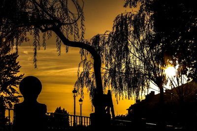 Silhouette trees against sky during sunset