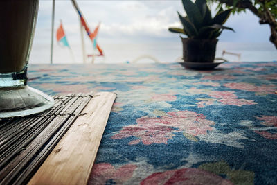 Surface level of wooden table against the sky