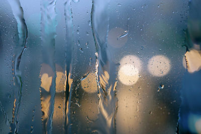 Raindrops on the windshield of the car. focus selected. blur background