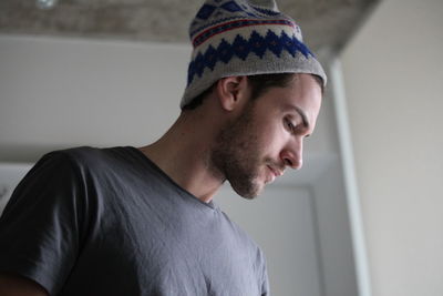 Portrait of young man looking away at home