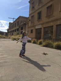 Full length of man walking on street in city