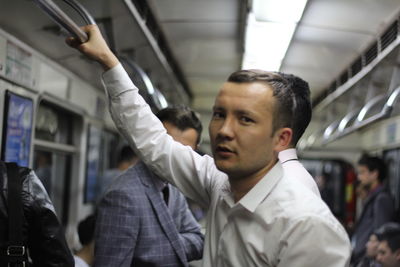 Portrait of man standing by train