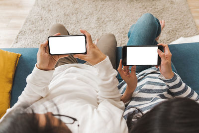 Midsection of woman holding mobile phone