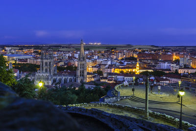 High angle view of illuminated town against sky at night