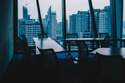 Empty chairs and table in building