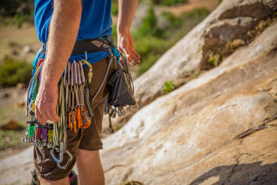 Midsection of man standing with ropes