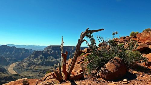 Scenic view of mountains against clear blue sky