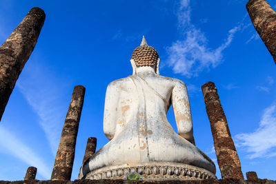 Low angle view of statue against blue sky