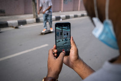 Close-up of man using mobile phone