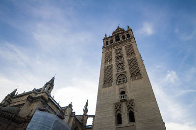 Low angle view of clock tower in city against sky