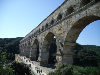 Low angle view of arch bridge against sky