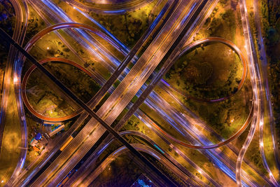 Directly above of illuminated highway at night