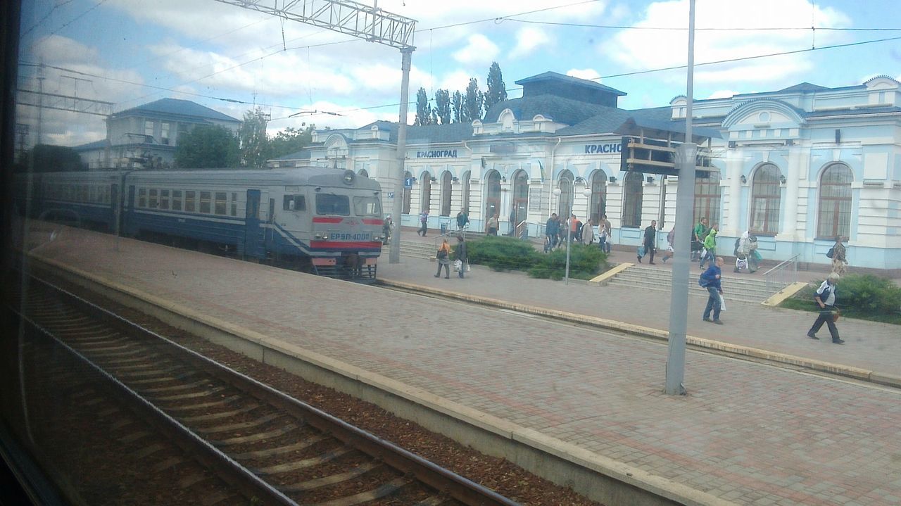 railroad track, public transportation, transportation, rail transportation, railroad station platform, railroad station, train - vehicle, mode of transport, architecture, built structure, travel, passenger train, train, indoors, building exterior, men, person, incidental people, public transport