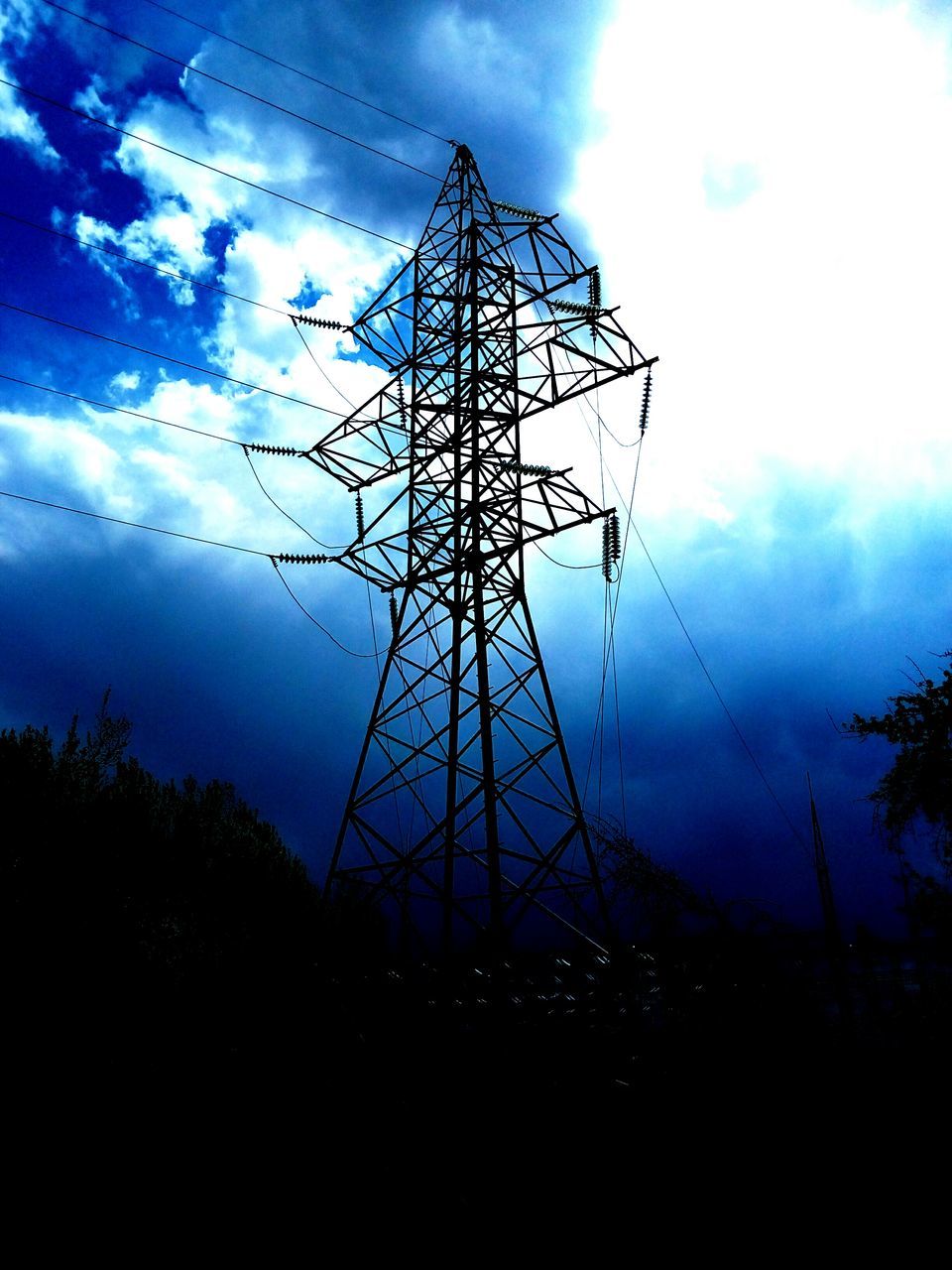 electricity pylon, silhouette, electricity, low angle view, sky, power line, power supply, fuel and power generation, cloud - sky, technology, connection, cable, cloud, dusk, cloudy, nature, tree, outdoors, no people, sunset
