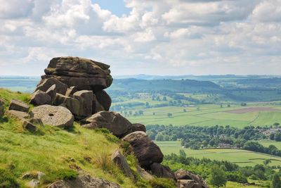 Scenic view of rocks on field against sky