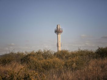 View of tower on field against sky