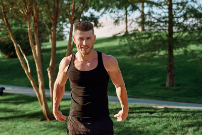 Portrait of young woman exercising in park