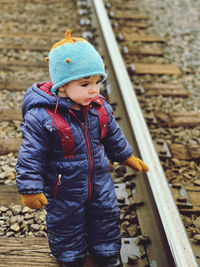 Full length of boy standing on railroad track