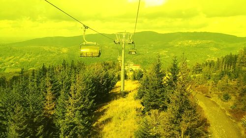 Overhead cable car on mountain against sky