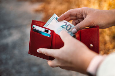 Cropped hand of person holding paper currency