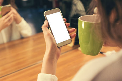 Midsection of woman using mobile phone