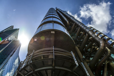 Low angle view of modern building against cloudy sky