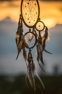 Close-up of feather hanging against sky