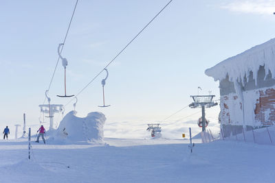 View of ski lift on snowcapped mountain