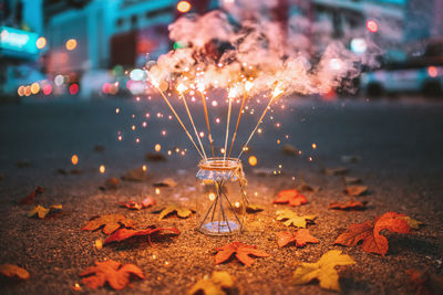 Illuminated street light in city at night