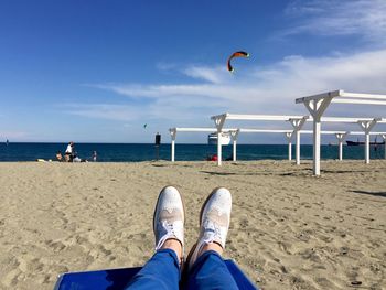 Low section of person relaxing on beach