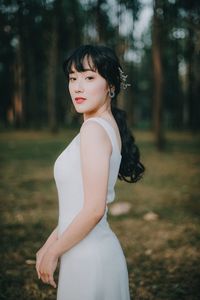 Portrait of beautiful young woman standing in park