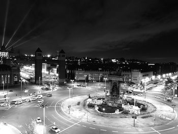 High angle view of illuminated city against sky at night