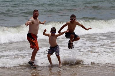 Full length of shirtless boy at beach