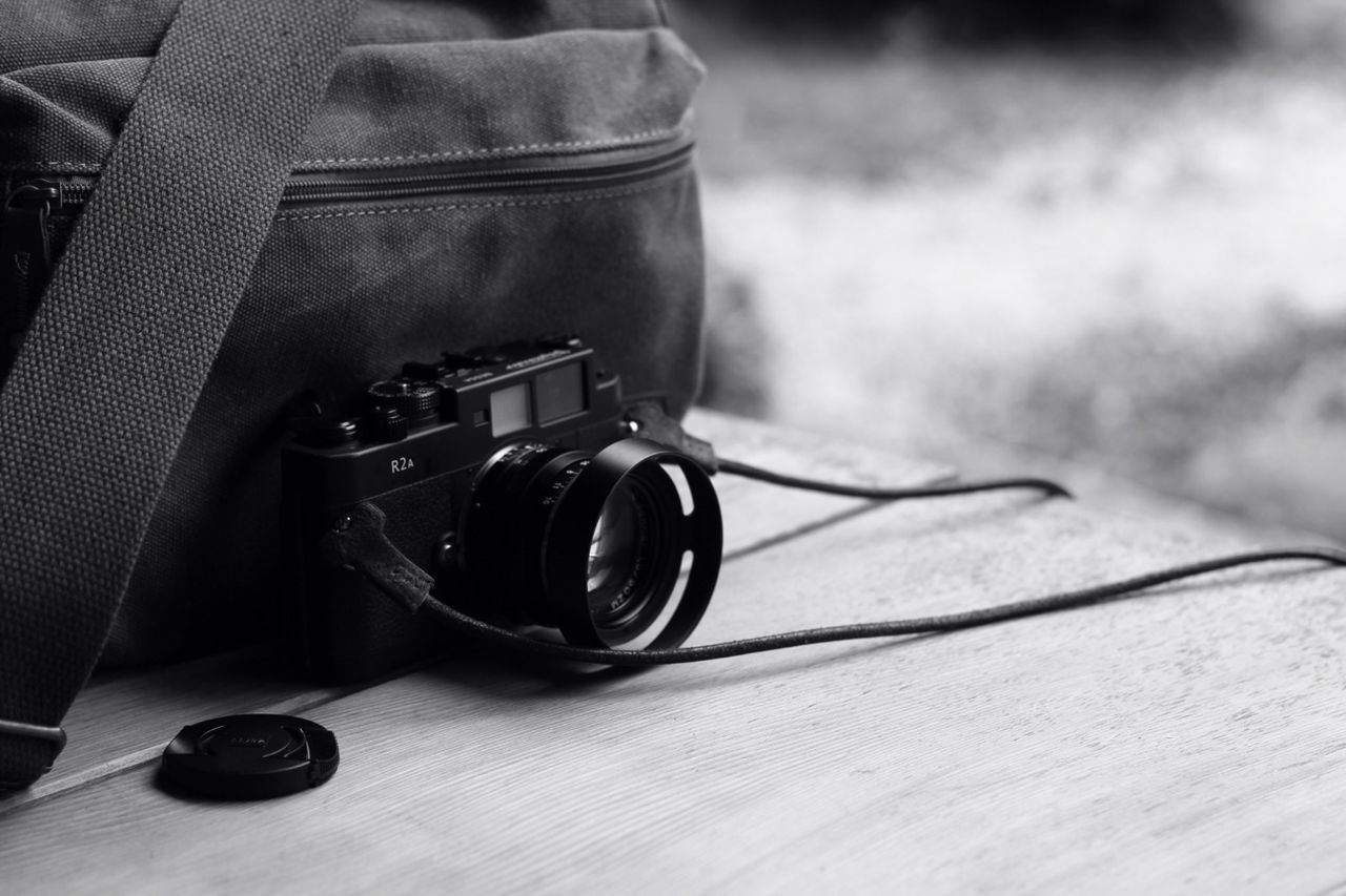 close-up, still life, table, focus on foreground, single object, photography themes, selective focus, drink, sunglasses, technology, camera - photographic equipment, indoors, coffee cup, equipment, no people, old-fashioned, retro styled, part of, high angle view, eyeglasses