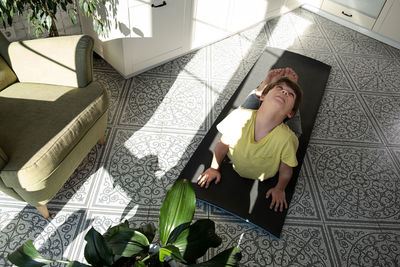 Little boy practicing yoga, stretching, fitness at home. distant online education training at home.