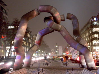 Statue of people in city at night