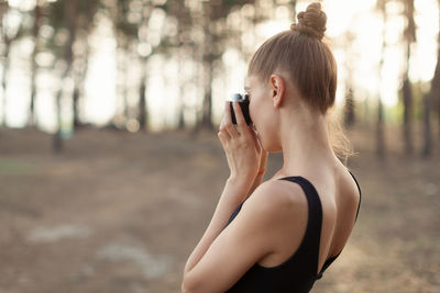 Young woman using mobile phone outdoors