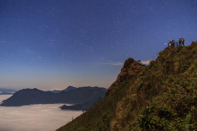 Scenic view of mountains against sky at night