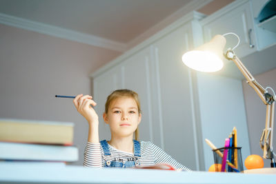 Portrait of girl studying at home