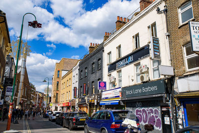 Panoramic view of city street and buildings against sky